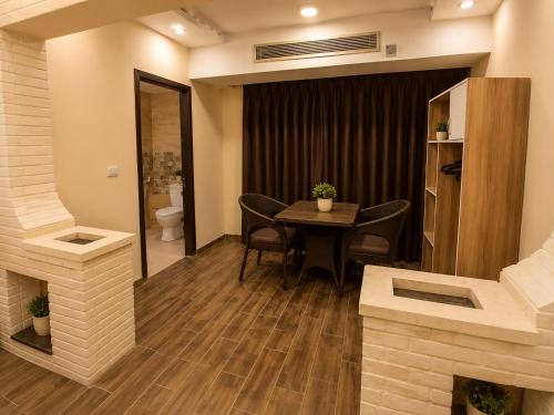 a room with a table and chairs and a toilet at Pyramids Front Gate Hotel in Cairo