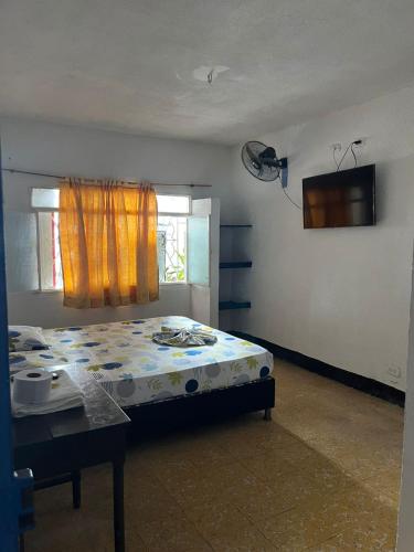 a bedroom with a bed and a table and a window at Guiapa en melgar in Melgar