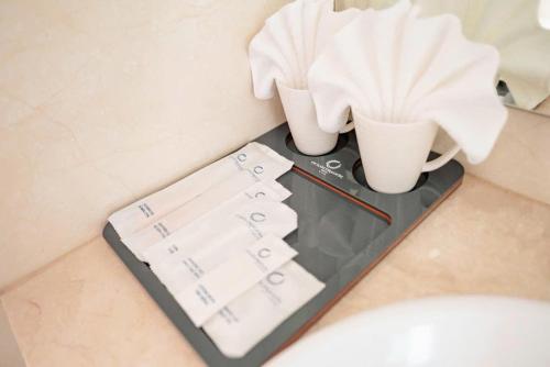 a tray with a fan and two cups on a counter at ocean dragon in Ha Long