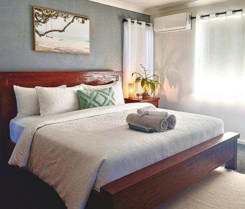 a bedroom with a bed with a towel on it at Executive King Suite - Ensuite in Holmview