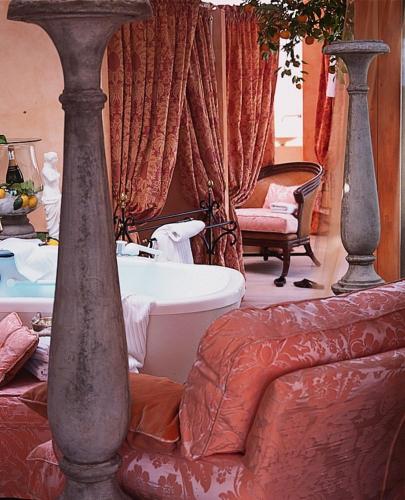 a room with a tub and a couch and a chair at Pension am Bodensee (Adults only) in Kressbronn am Bodensee