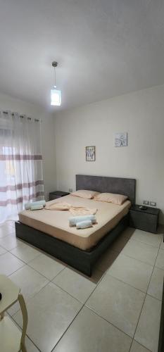 a bedroom with a bed with towels on it at Mali's Apartment in Tirana