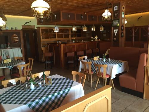 a restaurant with two tables and a bar at Hotel Schützenhaus in Brück