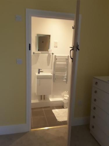 a bathroom with a sink and a toilet at Windylands in Chipping Sodbury