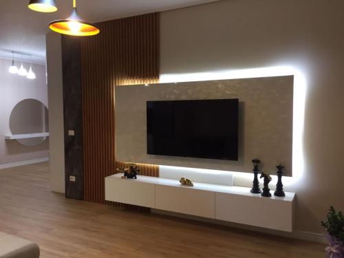 a living room with a television on a wall at Your Home Fier 2 in Fier