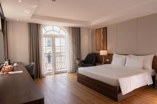 a hotel room with a large bed and a window at Devesun Boutique Hotel Phú Quốc in Phú Quốc