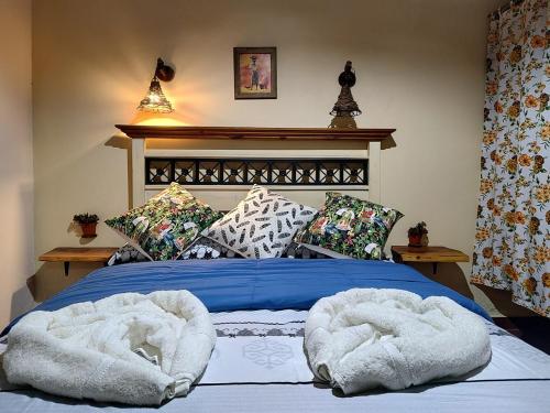 a bed with two towels on top of it at Cabañas Mónika III Norte in Huerta Grande