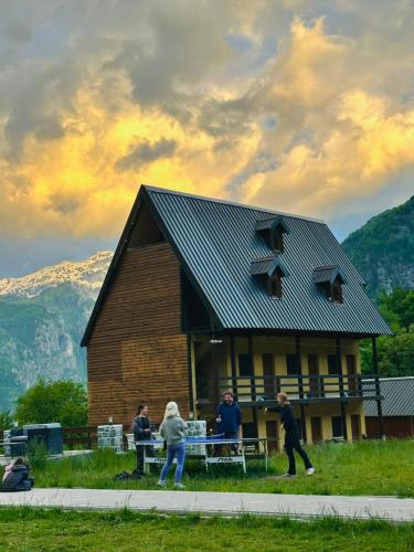 a group of people standing in front of a building at Guesthouse Gjoni Theth in Theth