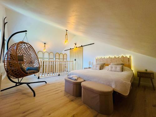 a bedroom with a large bed and a swing at Cocon Savoyard - Vues Alpes - 2 king size - Rando & VTT - Parking in Albertville