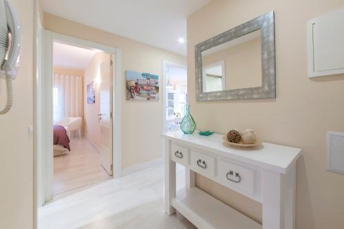 a bathroom with a white dresser and a mirror at Litoral Mar Beside the Beach in Portimão