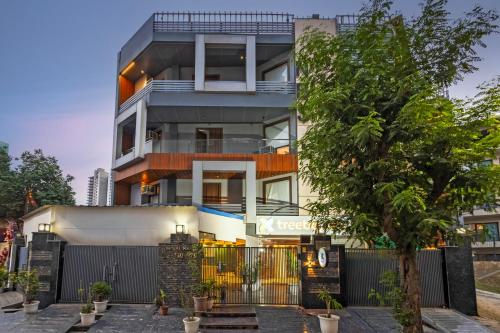 an apartment building with a tree in front of it at Treebo Noida Business Suites in Okhla