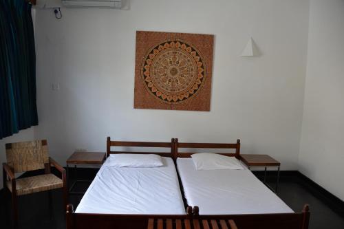 a bedroom with a bed and a picture on the wall at Flower Road Villa in Colombo