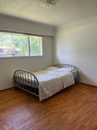 a bedroom with a bed in a room with a window at 6 bedroom house in Victoria