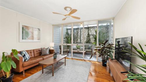 a living room with a couch and a table at Quirky and Captivating Kurra in Hawks Nest