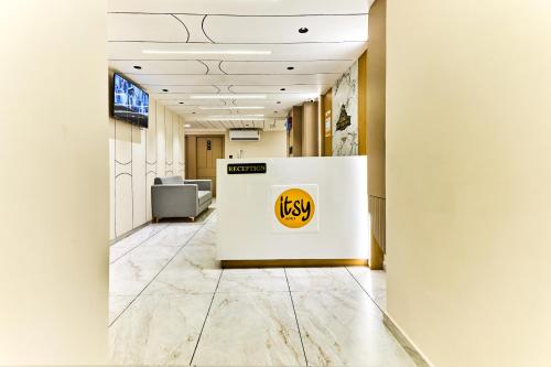 an office hallway with ahi logo on a wall at Itsy Hotels Grand CG in Ahmedabad