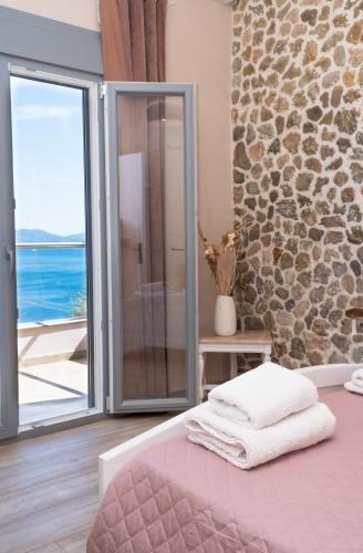 a bedroom with a pink bed with a view of the ocean at Barbati breathtaking views in Barbati