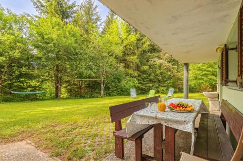 a table with a bowl of fruit sitting on a patio at House Fortin With Sauna Near Bloke Lake - Happy Rentals in Velike Bloke