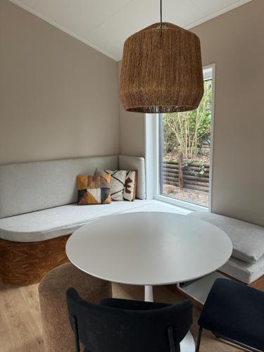 a living room with a white table and a couch at Casa Mundo in Nunspeet