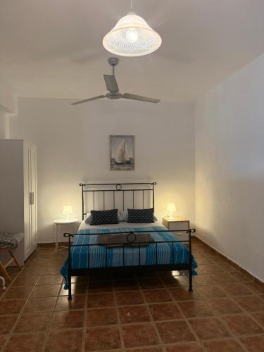 a bedroom with a bed and a light on the ceiling at Villa Aphrodite in Koundouros