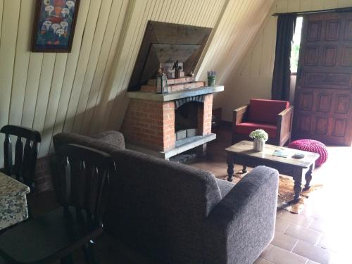 a living room with two couches and a fireplace at Villa Calas in Vara Blanca
