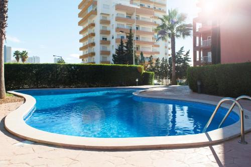 a swimming pool in front of a building at Litoral Mar Beside the Beach in Portimão