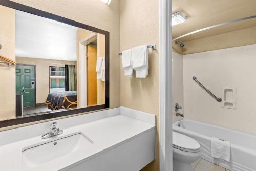 a bathroom with a sink and a toilet and a mirror at Super 8 by Wyndham Acworth/Atlanta Area in Acworth