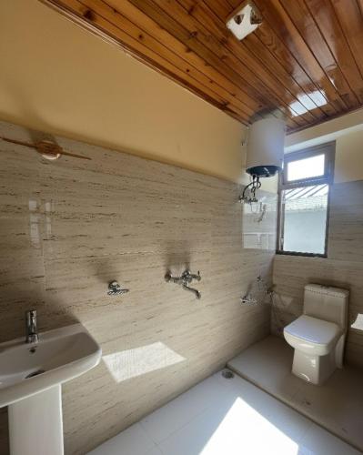 a bathroom with a sink and a toilet at Tilanjali Stay in Soreng