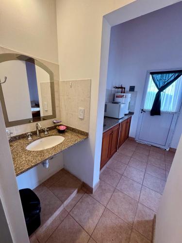 a bathroom with a sink and a counter with a mirror at Luna Vallista Apart Hotel in Seclantás