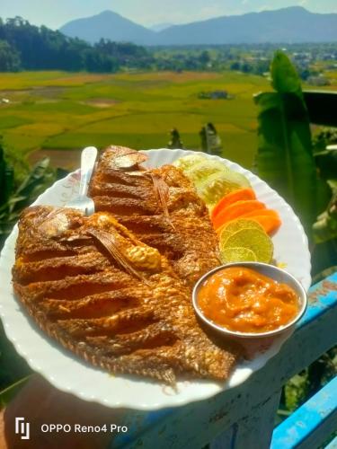 a plate of food with meat and a bowl of sauce at Hotel crunchy shadowbegnas in Deorāli
