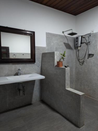 a bathroom with a sink and a mirror at Villa Balapitiya Beach in Balapitiya