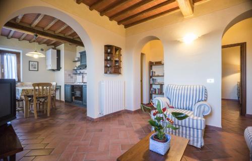 a living room with two chairs and a table at Carlino Vacanze in Gaiole in Chianti