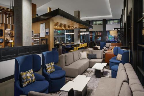 a lobby with couches and tables in a library at Hyatt Centric Mountain View in Mountain View