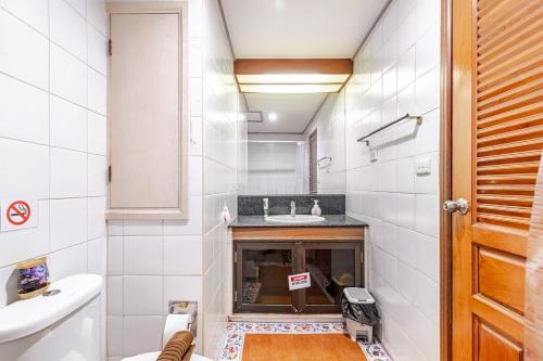 a small bathroom with a sink and a toilet at 2BR Duplex in central Chitlom in Bangkok