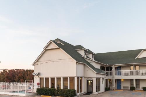 a large white building with a green roof at Motel 6-Fort Worth, TX - White Settlement in Fort Worth