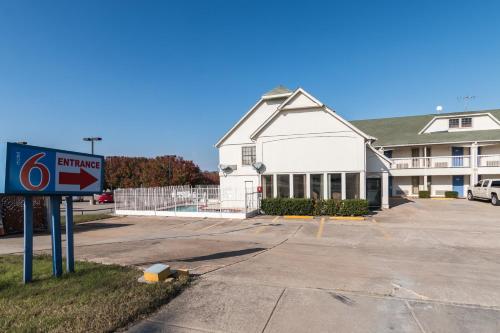 a building with a sign in front of a parking lot at Motel 6-Fort Worth, TX - White Settlement in Fort Worth