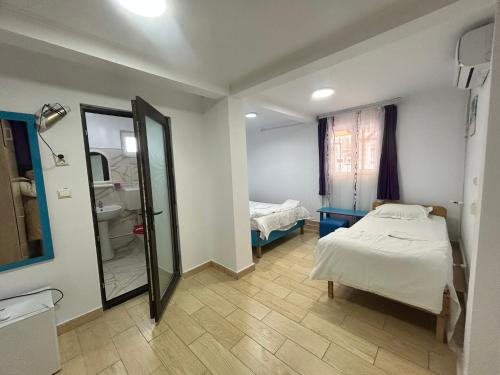 a hospital room with a bed and a mirror at Camere de închiriat Doriana in Vama Veche