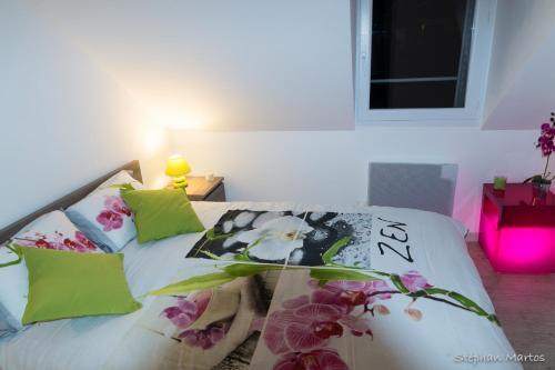 a bedroom with a bed with flowers on it at Le Sancy in Le Mont-Dore