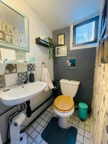 a small bathroom with a toilet and a sink at La Vannière in Le Poujol-sur-Orb