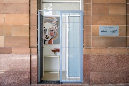 a glass doorway to a building with a painting at Terminus Apartment Hotel, an Ascend Collection Hotel in Newcastle