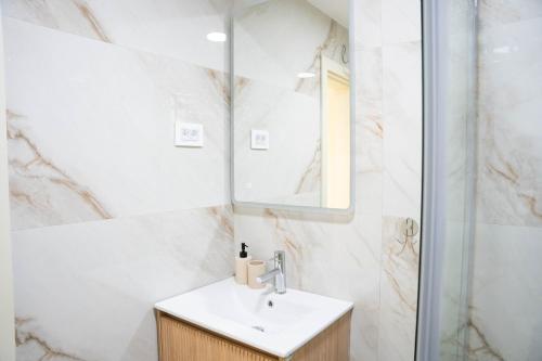 a bathroom with a sink and a mirror at Stevovic Apartments - Brand New Apartments in Tivat