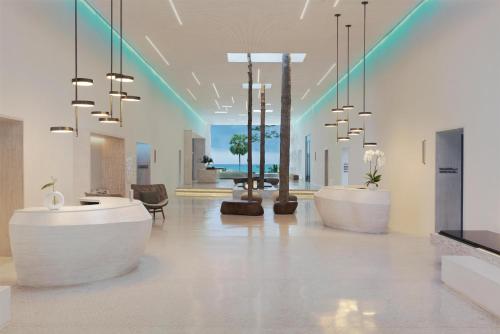 a lobby with two reception desks and chandeliers at Hyatt Regency Koh Samui in Chaweng
