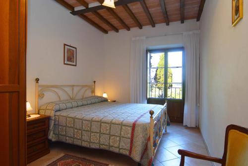a bedroom with a bed and a window at Agriturismo Cameli in Certaldo