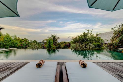 a view of a swimming pool with a pair of sandals at Villa Olala Penida in Nusa Penida
