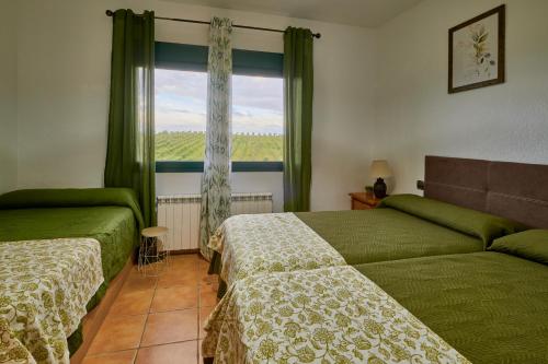 a bedroom with two beds and a window at FINCA VALDELAJARA a 20 minutos de Puy du Fou in Toledo