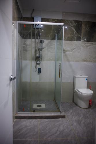 a shower in a bathroom with a toilet at Taisia & Liku Homes in Nuku‘alofa