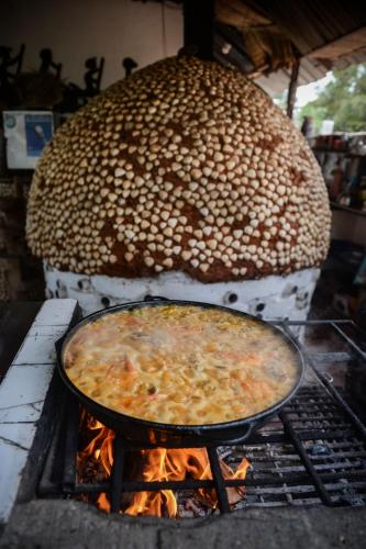 a pot of food cooking on a grill at Saldomar B&Biosphere in Bubaque