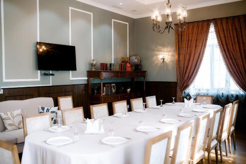 a dining room with a long table and chairs at Park Hotel in Karagandy