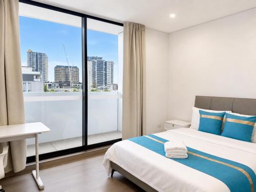 a hotel room with a bed and a large window at Granville Studio Ensuite toilet and kitchen in Clyde