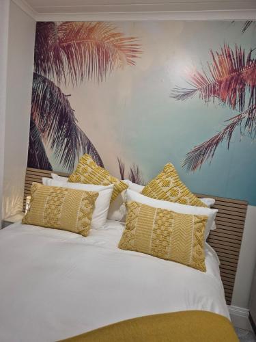 a bedroom with a bed with yellow and white pillows at The One Wave - 2 Bed Serenity meets Luxury in Midrand