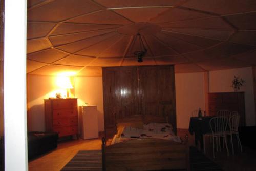 a room with a bed and a large tent at Pod Zachrypniętym Kogutem in Glewo